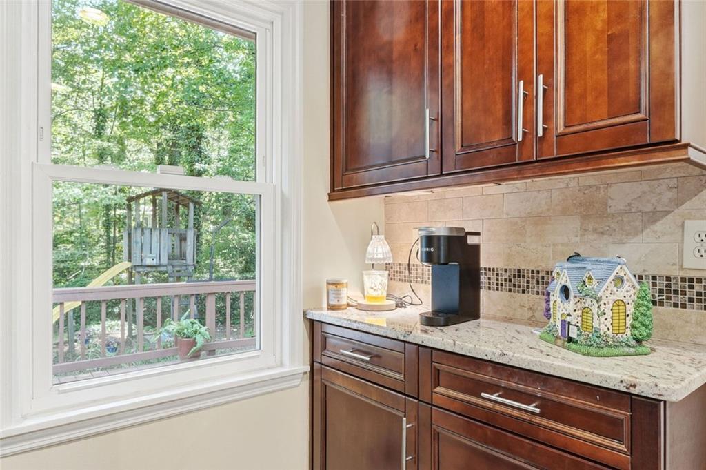 1837 Chancery Lane Atlanta, GA 30341 - Photo 13 of 46 a kitchen with granite countertop wooden cabinets a potted plant and a window