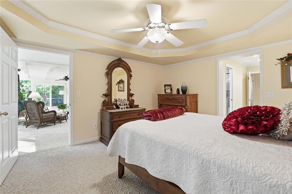 1837 Chancery Lane Atlanta, GA 30341 - Photo 21 of 46 a bedroom with a large bed and a chandelier