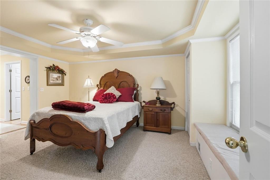 1837 Chancery Lane Atlanta, GA 30341 - Photo 22 of 46 a bedroom with a bed and a chandelier