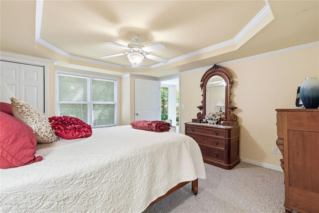 1837 Chancery Lane Atlanta, GA 30341 - Photo 23 of 46 a bedroom with a bed a chandelier and dresser