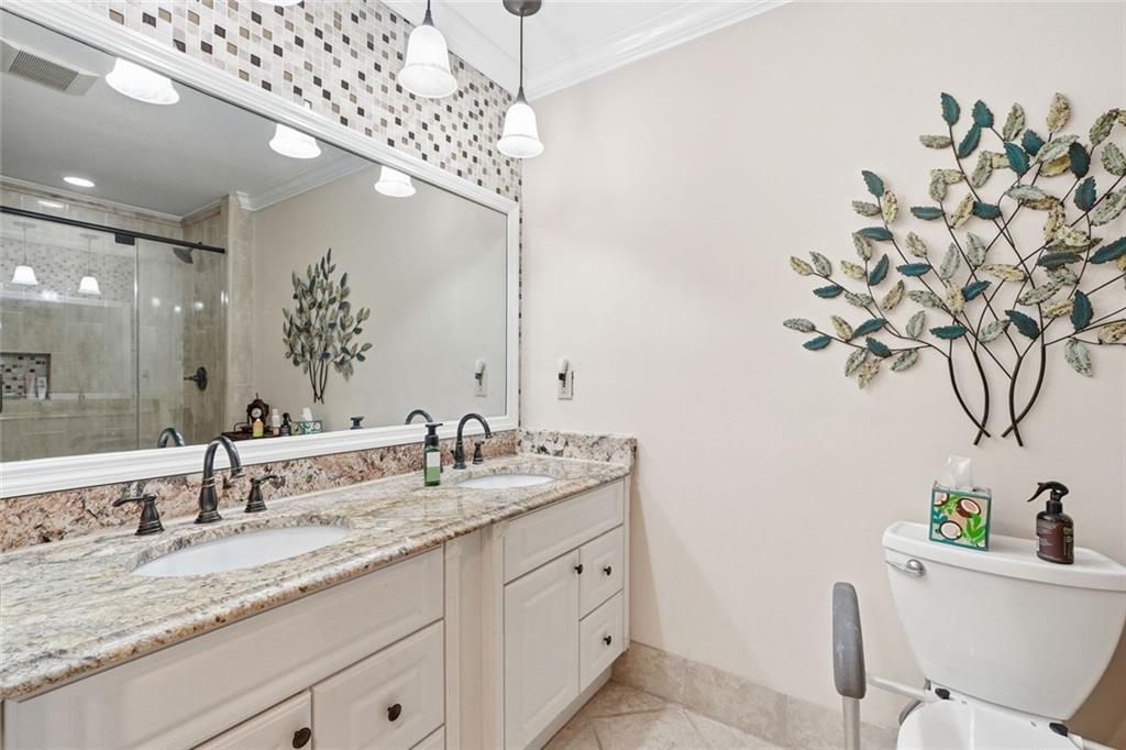 1837 Chancery Lane Atlanta, GA 30341 - Photo 25 of 46 a bathroom with a granite countertop sink a mirror and a bathtub