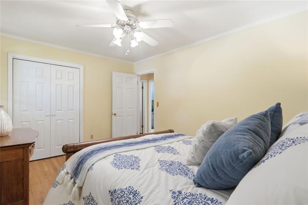 1837 Chancery Lane Atlanta, GA 30341 - Photo 31 of 46 a bedroom with a large bed and a chandelier