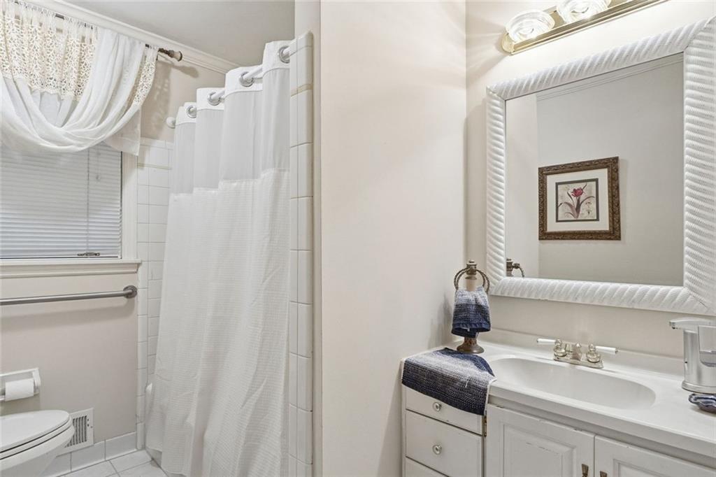 1837 Chancery Lane Atlanta, GA 30341 - Photo 36 of 46 a bathroom with a sink a toilet and a mirror