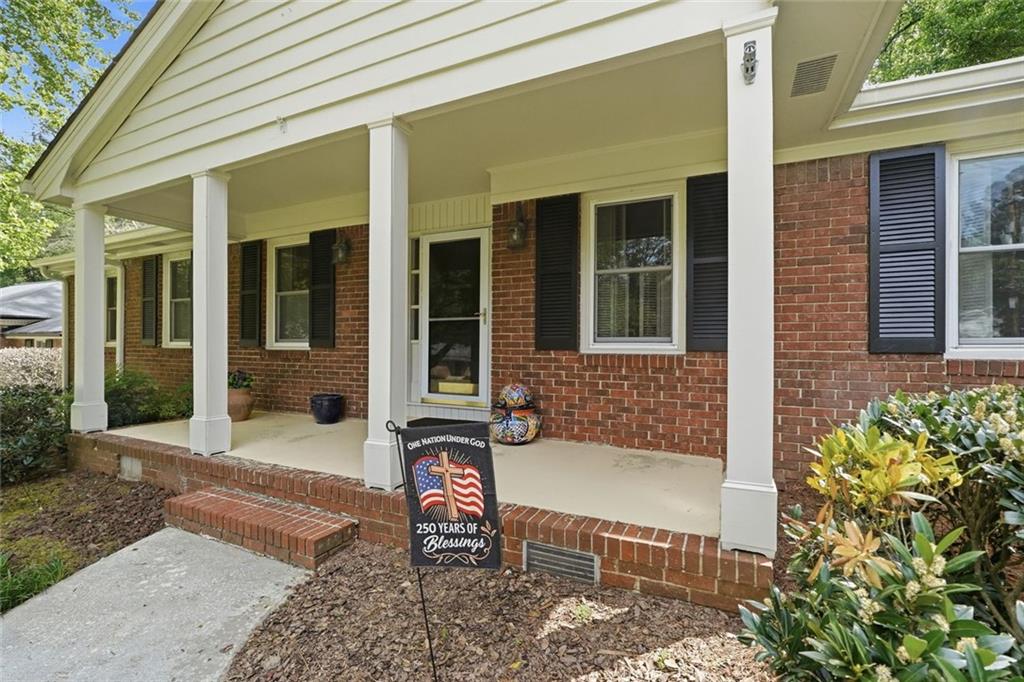 1837 Chancery Lane Atlanta, GA 30341 - Photo 5 of 46 front view of a house with a chairs and table in a patio