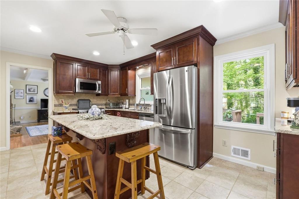 1837 Chancery Lane Atlanta, GA 30341 - Photo 10 of 46 a kitchen with stainless steel appliances granite countertop a refrigerator a sink a stove a microwave and island