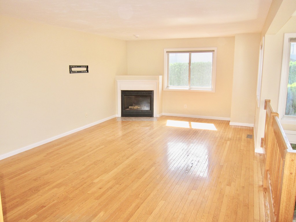243 Captain Eames Circle, Unit 243 Ashland, MA 01721 - Photo 2 of 16 a view of empty room with wooden floor and fan
