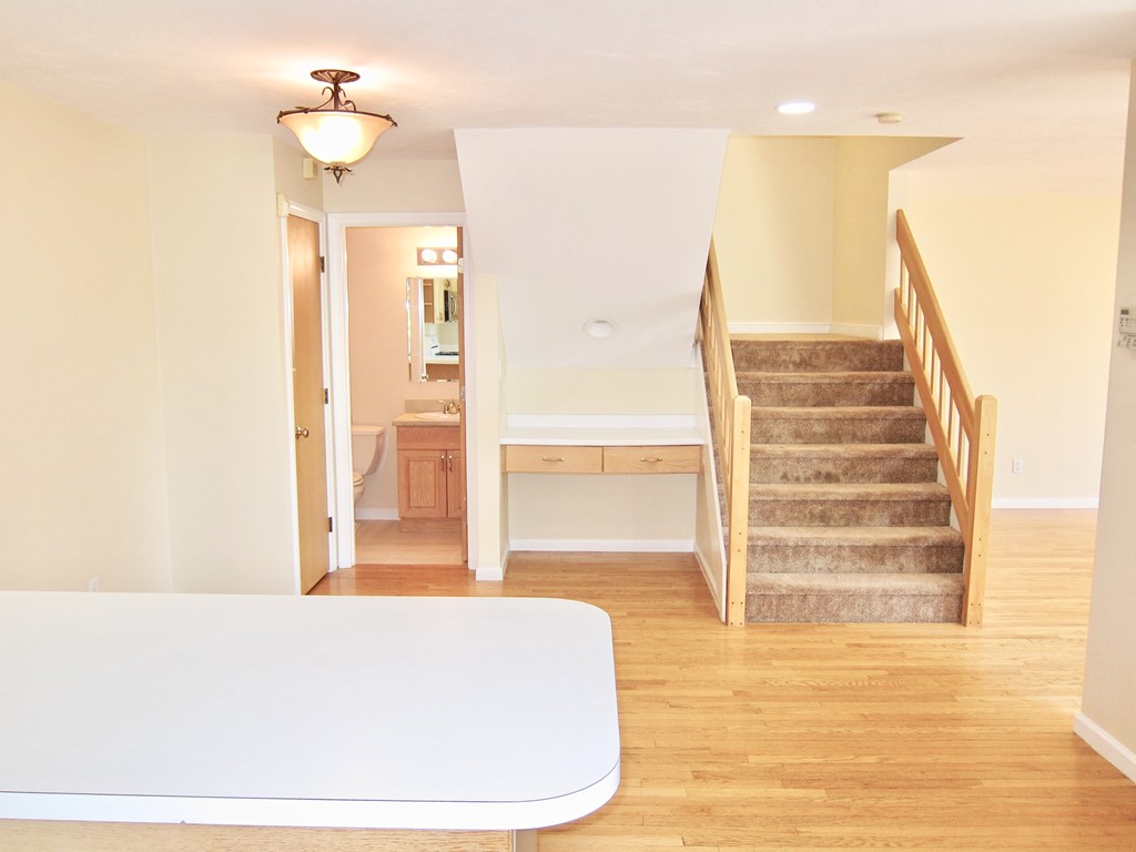 243 Captain Eames Circle, Unit 243 Ashland, MA 01721 - Photo 7 of 16 a living room with furniture and wooden floor