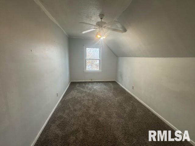 1013 North 2nd Street Clinton, IA 52732 - Photo 10 of 14 an empty room with a chandelier fan and windows