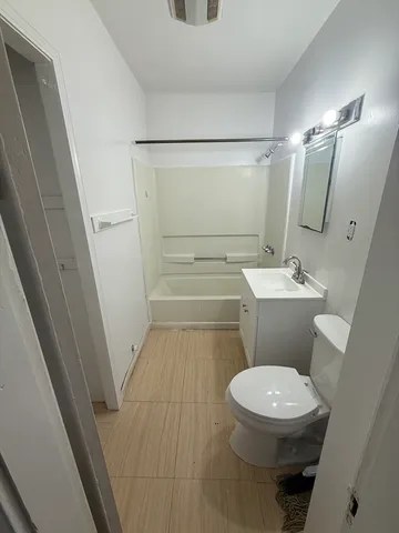 a white toilet sitting next to a bathroom sink