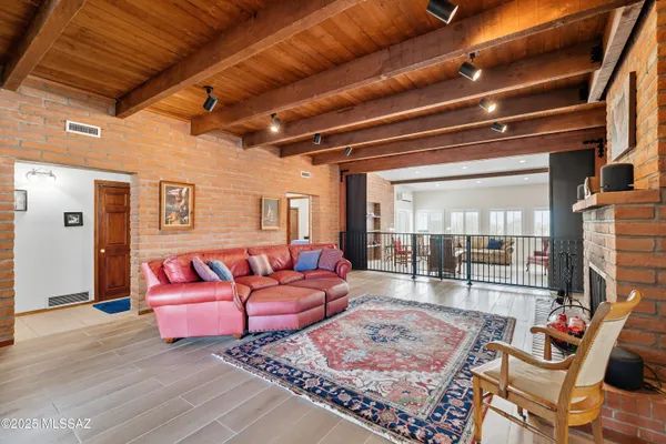 a living room with furniture a rug and a chandelier