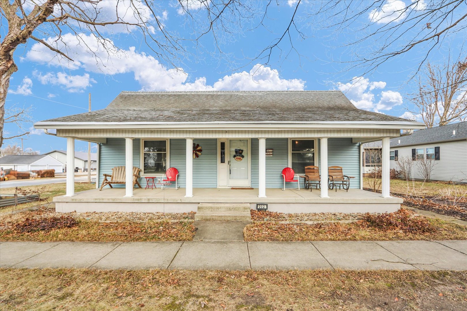 front view of a brick house with a patio