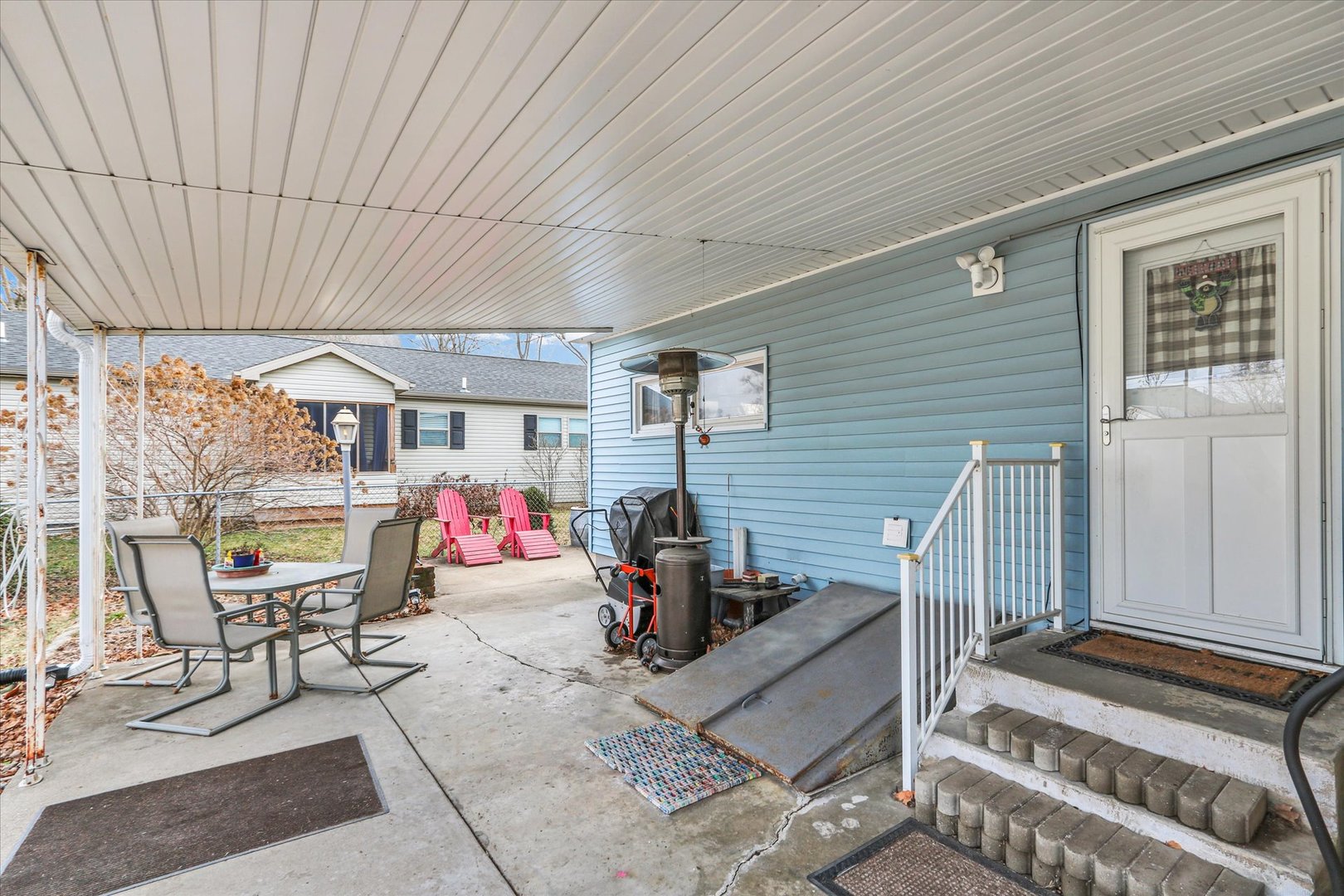 202 East Sherman Street St. Joseph, IL 61873 - Photo 21 of 24 a view of a patio with table and chairs potted plants
