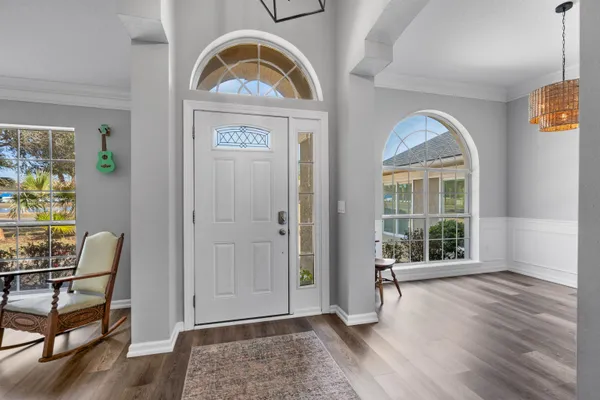a view of a workspace with furniture and wooden floor