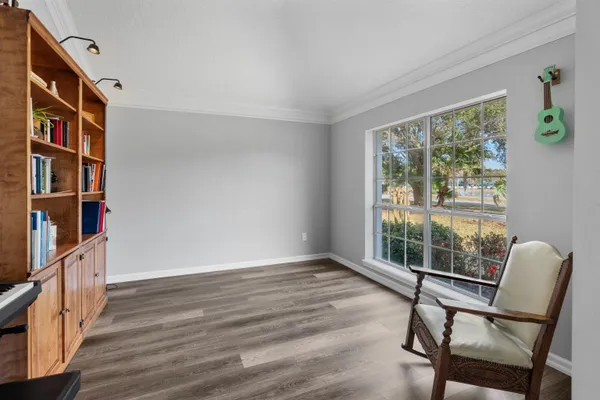 a view of a dining room with furniture a chandelier and wooden floor