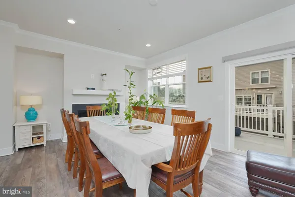 a dining room with furniture a rug and wooden floor
