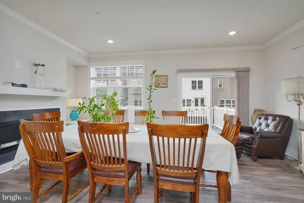 a view of a dining room with furniture and a potted plant