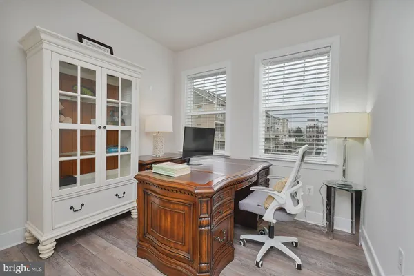 a bedroom with a bed and a lamp on dresser