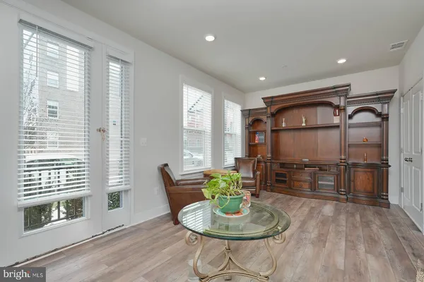 a living room with furniture a window and stainless steel appliances