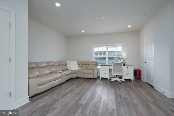 a large white kitchen with cabinets and wooden floor