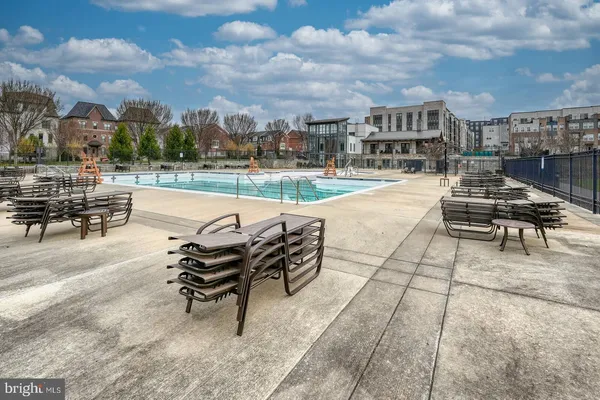 a view of a swimming pool with a table and chairs in patio
