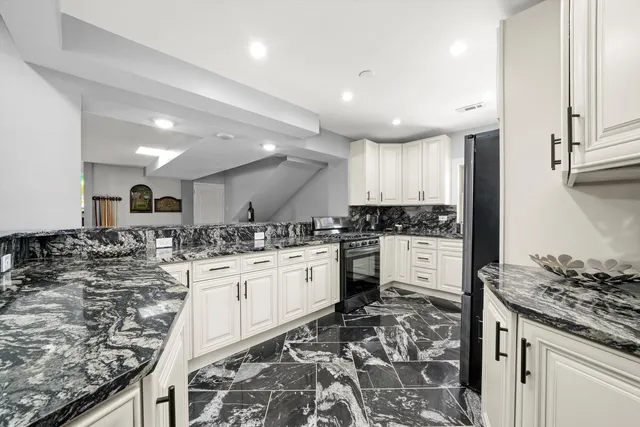 a bedroom with a bed and a flat tv screen on the dresser