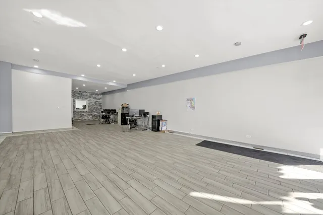 a view of a room with wooden floor and furniture