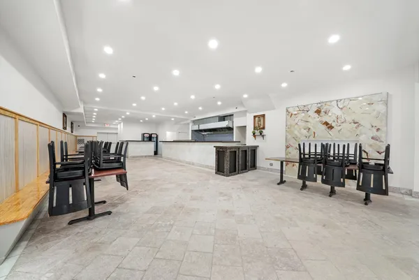 a dining room with furniture and wooden floor