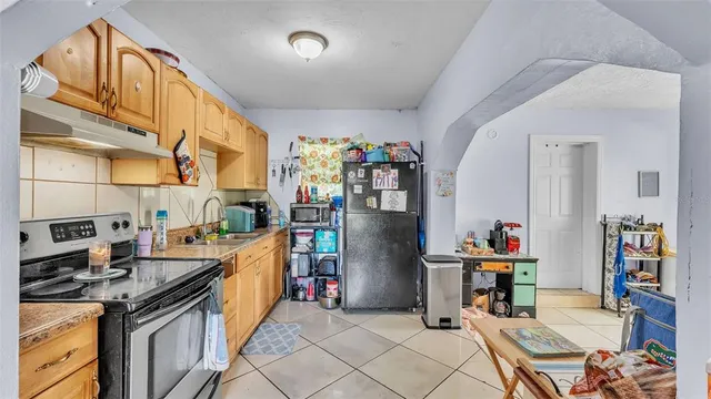 a kitchen that has a lot of cabinets and appliances