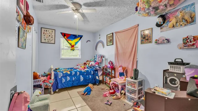 a bed room with a bed and a chandelier