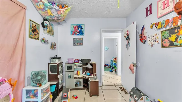 a living room with furniture and a book shelf
