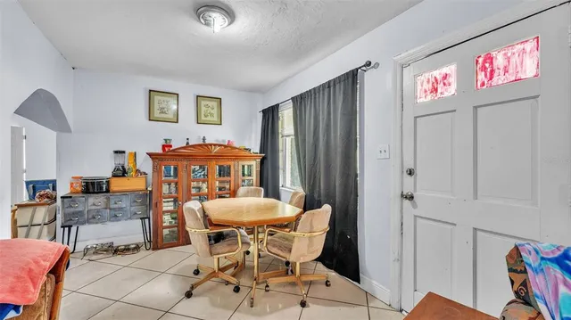 a view of a dining room with furniture and chandelier