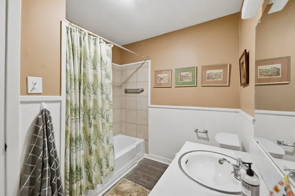 a bathroom with a sink toilet and shower