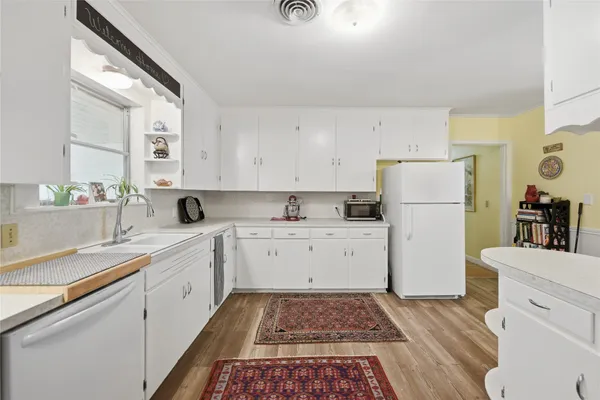 a kitchen with a refrigerator and a sink