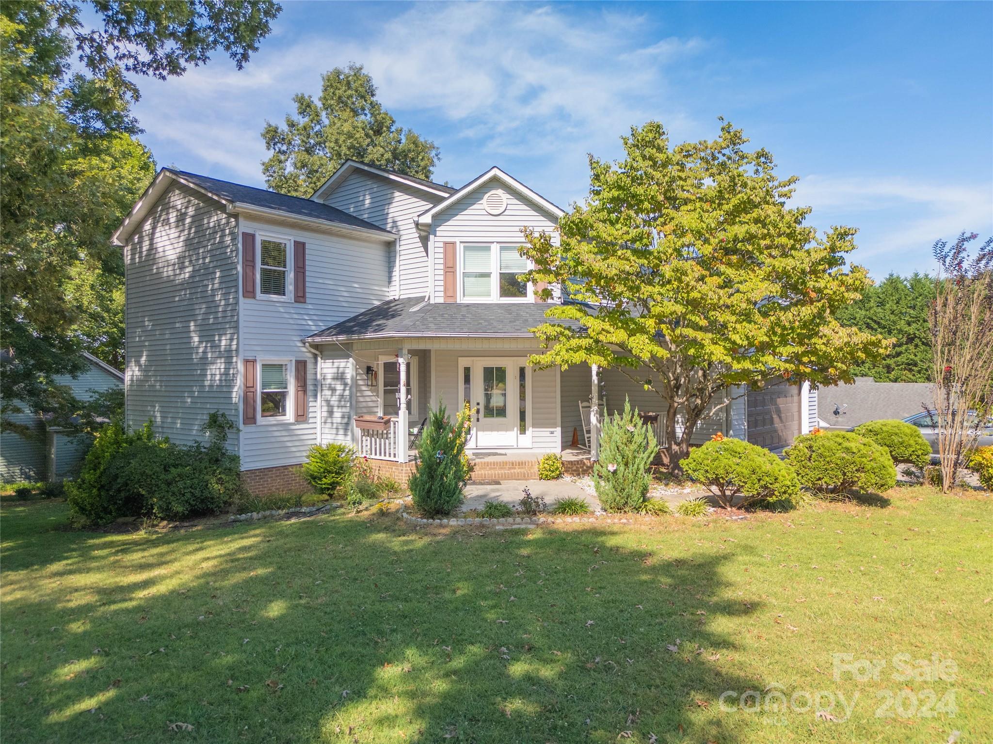 a front view of a house with garden