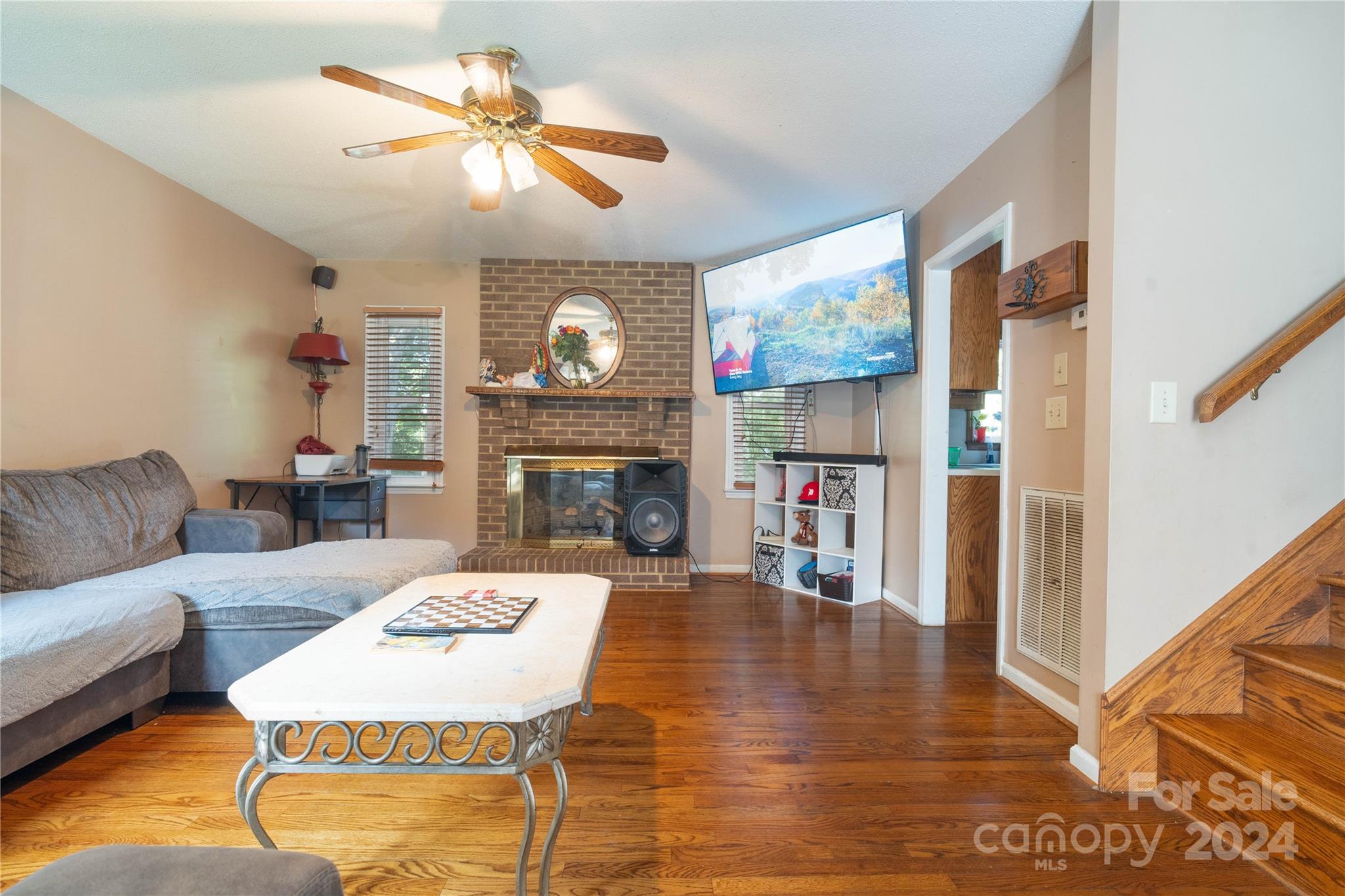 4710 Bert Huffman Drive Granite Falls, NC 28630 - Photo 11 of 28 a living room with furniture a fireplace and a chandelier