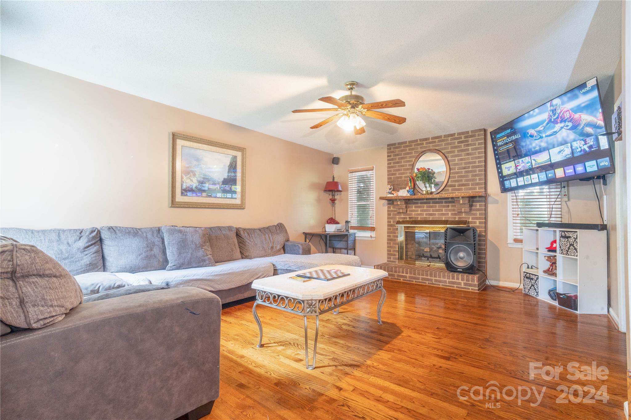 4710 Bert Huffman Drive Granite Falls, NC 28630 - Photo 12 of 28 a living room with furniture a fireplace and a flat screen tv