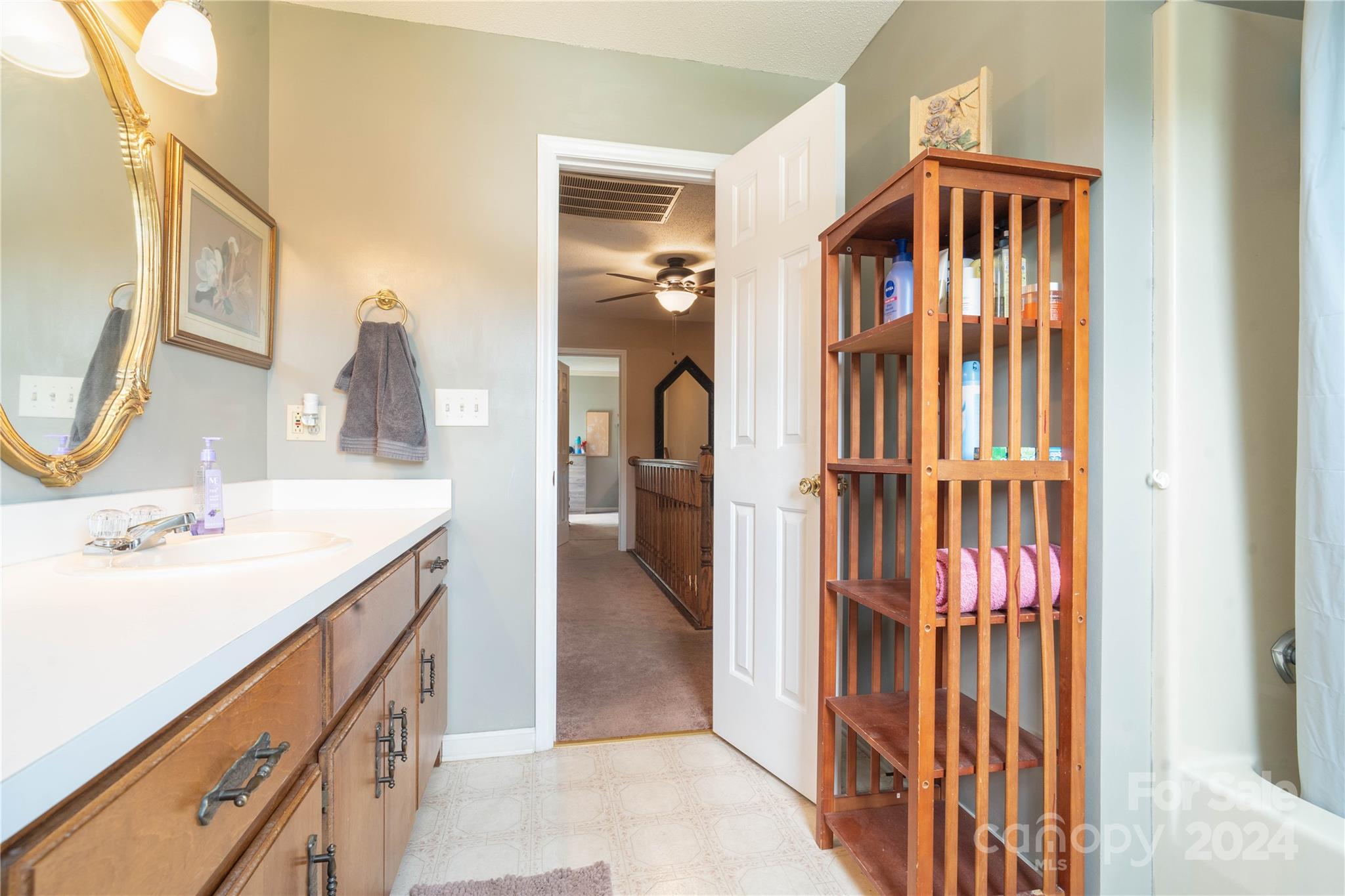 4710 Bert Huffman Drive Granite Falls, NC 28630 - Photo 19 of 28 a en suite bathroom with a sink a mirror and a shower