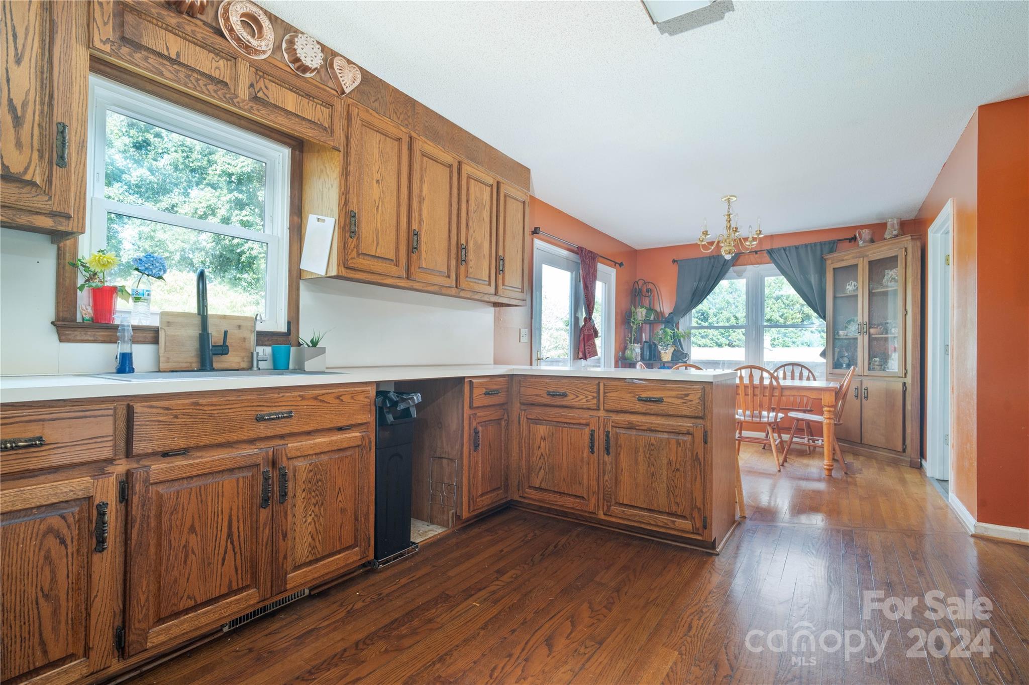 4710 Bert Huffman Drive Granite Falls, NC 28630 - Photo 8 of 28 a kitchen with sink cabinets and wooden floor