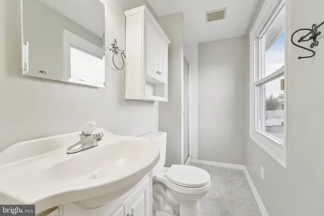 a view of a house with a big yard and large trees