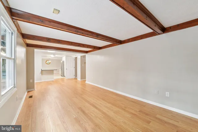 a view of kitchen with stove and cabinets