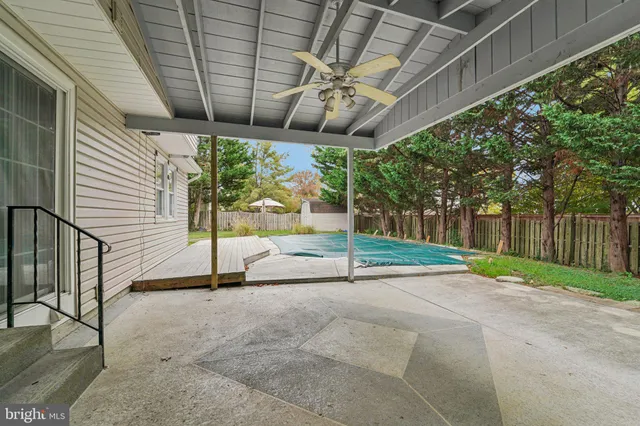a house view with swimming pool and garden space