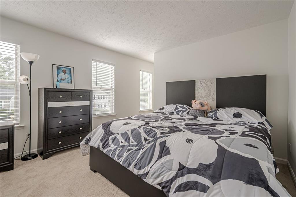 3403 Spring Harbour Drive Doraville, GA 30340 - Photo 12 of 27 a bed sitting in a bedroom and dresser