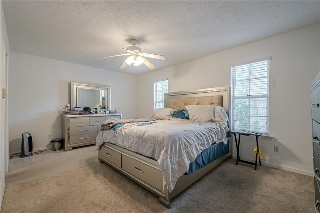 3403 Spring Harbour Drive Doraville, GA 30340 - Photo 16 of 27 a spacious bedroom with a bed and a ceiling fan