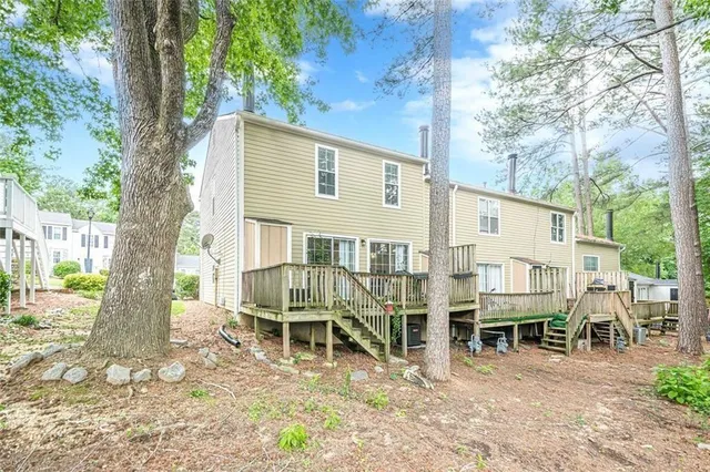 a roof deck with table and chairs under an umbrella