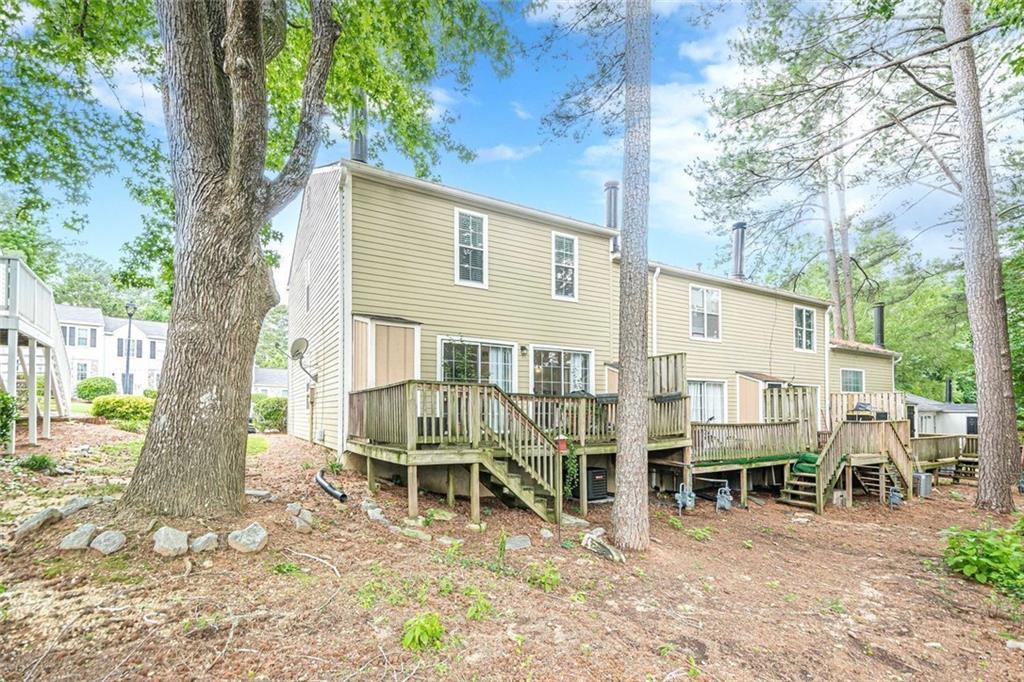 3403 Spring Harbour Drive Doraville, GA 30340 - Photo 22 of 27 a roof deck with table and chairs under an umbrella