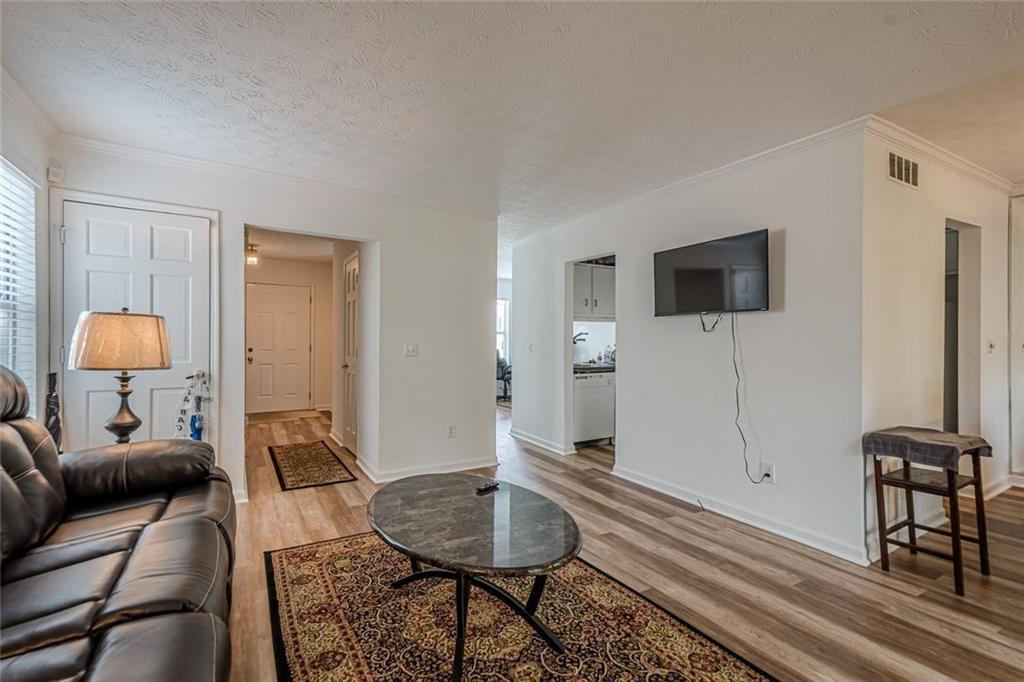 3403 Spring Harbour Drive Doraville, GA 30340 - Photo 7 of 27 a living room with furniture and a flat screen tv