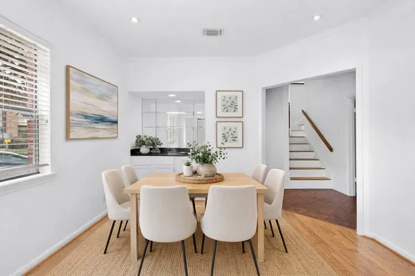 a view of a livingroom with wooden floor and a fireplace