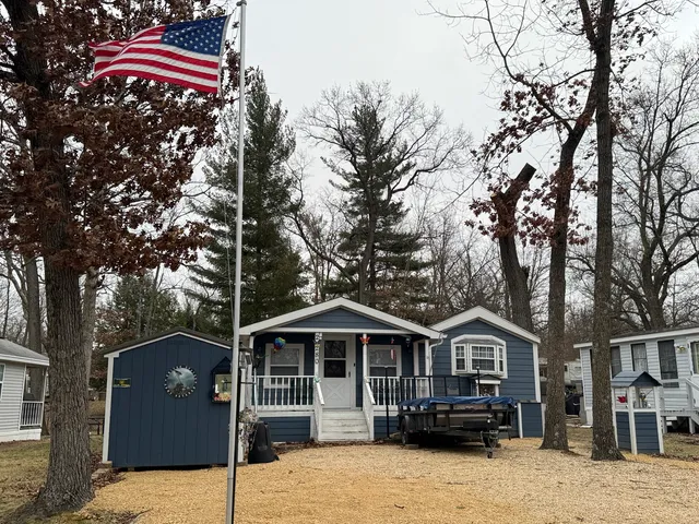 a front view of a house with a yard covered in snow