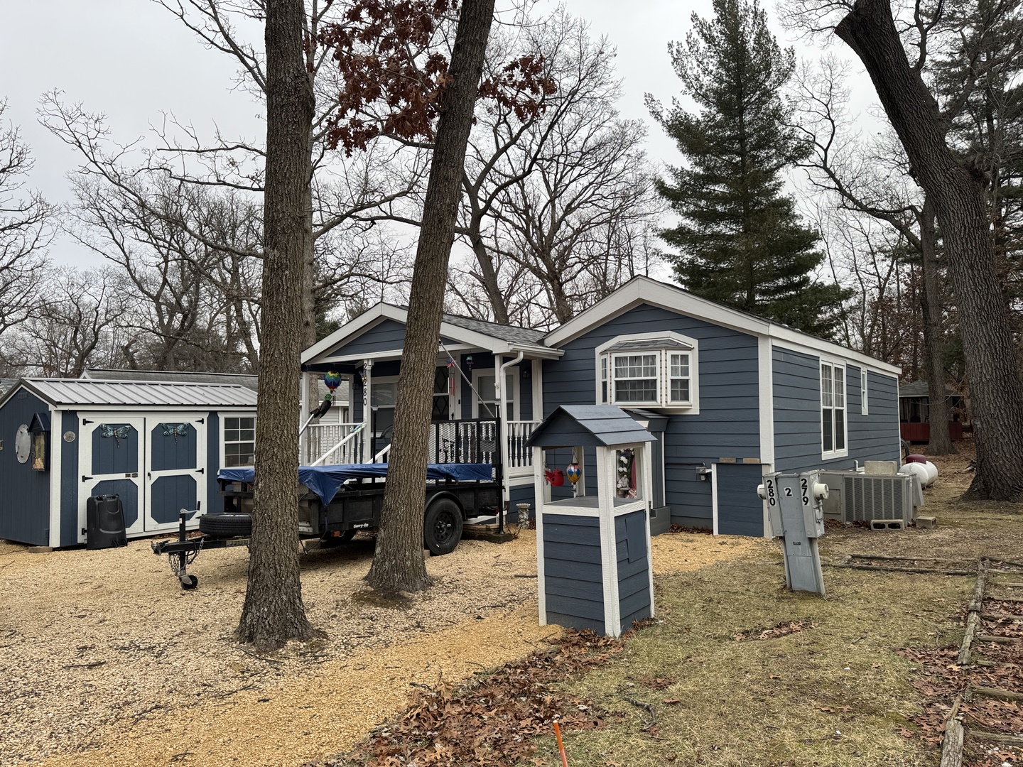 2-280 Woodhaven Sublette, IL 61367 - Photo 2 of 17 a front view of a house with a yard covered in snow