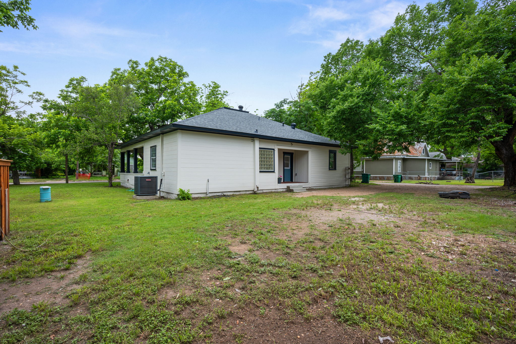 602 East 6th Street Cameron, TX 76520 - Photo 32 of 40 Rear exterior featuring white horizontal siding and a dark shingle roof